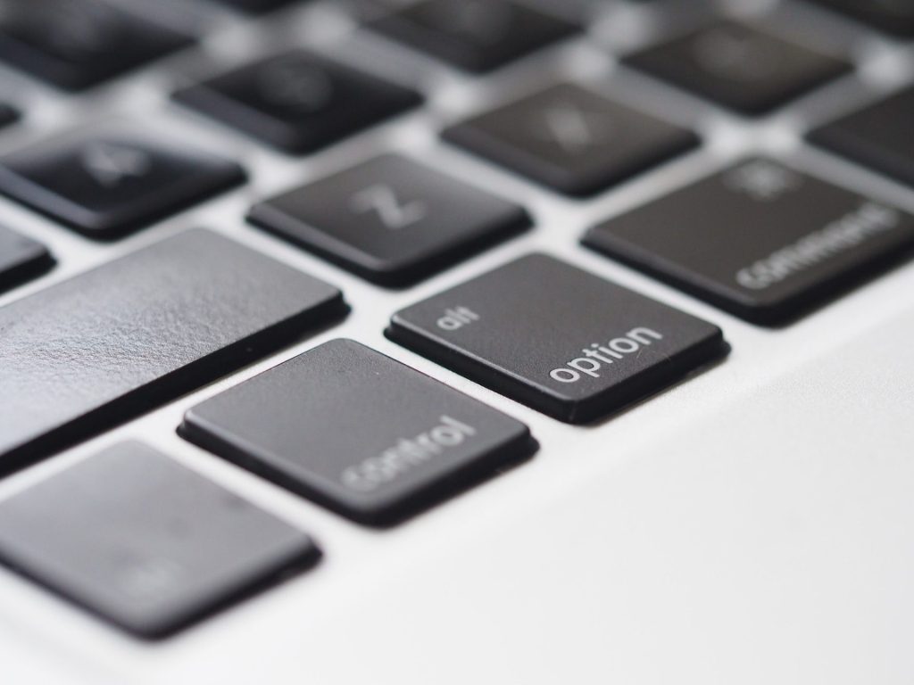 close up shot of macbook keyboard focused on the option key
